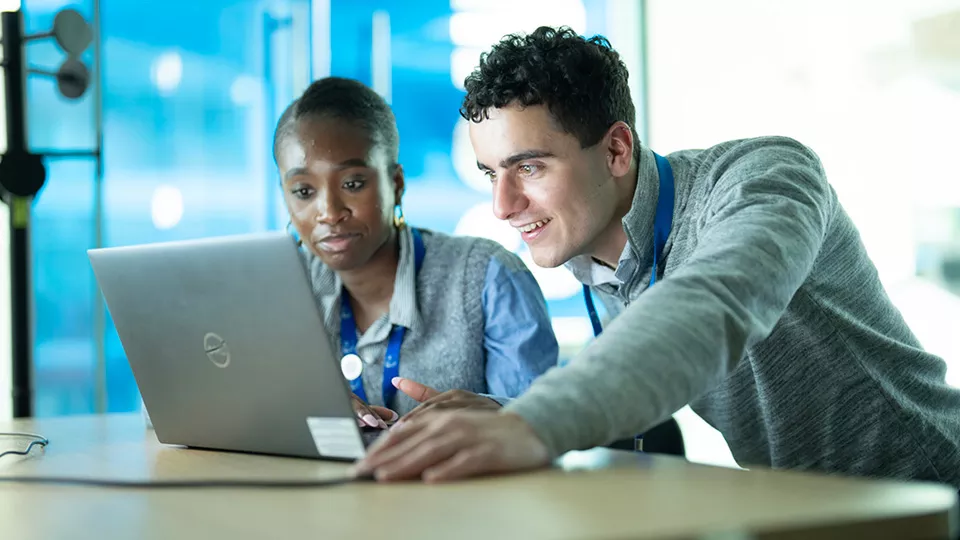 KBR employees looking at a computer