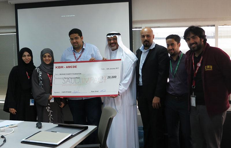 KBR IMPACT members in Saudi Arabia present a donation to Mudhar Charity CEO Mohammed Jawad