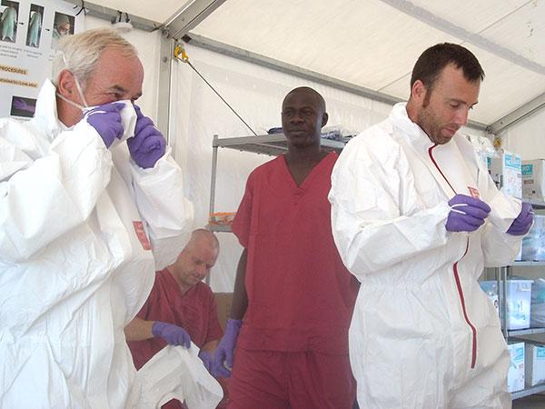 KBR employees preparing to enter the Ebola patient area to carry out maintenance tasks