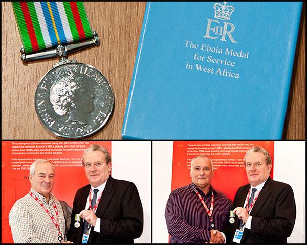 Richard Card presents Dave Butler and Jon Stewart with the Ebola Medal for Service Awards from the UK Government